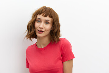 Fototapeta premium horizontal photo of a sweet, shy, pleasant woman standing on a white background with an empty space for inserting an advertising layout