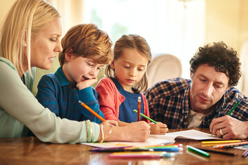 Fototapeta premium Time to get creative. Cropped shot of a family drawing and colouring in pictures together at home.