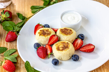 Homemade cheesecake with fresh strawberries and blueberries dessert - healthy organic summer dessert pie cheesecake. Vanilla Cheese Cake