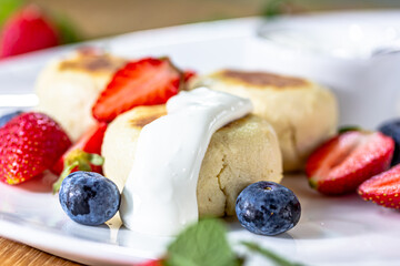 Homemade cheesecake with fresh strawberries and blueberries dessert - healthy organic summer dessert pie cheesecake. Vanilla Cheese Cake