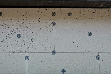 texture of white dirty foam blocks for insulation in the wall on the street