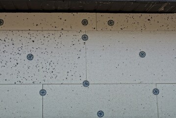 texture of white dirty foam blocks for insulation in the wall on the street