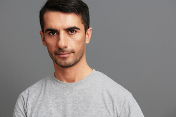 Fototapeta premium handsome man in gray t-shirts posing lifestyle casual wear cropped view