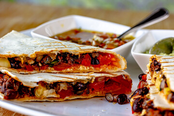 Savory crepe filled with spicy ground beef, cheese, kidney beans, lettuce and tomatoes. Topped with...