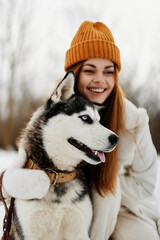 young woman with husky outdoor games snow fun travel winter holidays