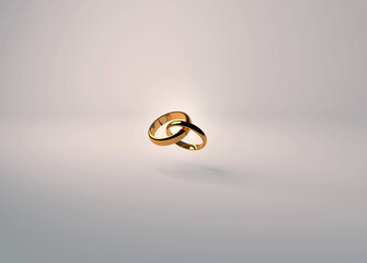 Interlocking gold wedding rings on a soft cream background for invitations and placards.