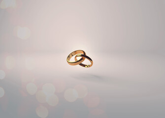 Interlocking gold wedding rings with sparkling reflections on a soft cream background for invitations and placards. 
