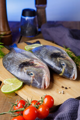 Raw peeled dorado fish with cooking ingredients. Fresh fish on a wooden background