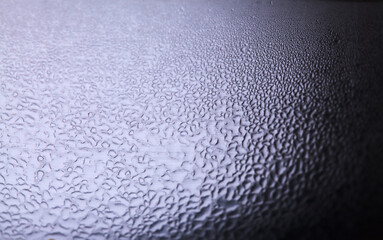 Macro background with water droplets condensation pattern on metal surface 