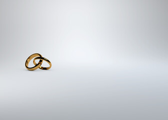 Interlocking gold wedding rings on a soft white background for save the date, invitations and placards. 
