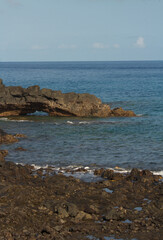 Fototapeta na wymiar Lava rocks by the seashore