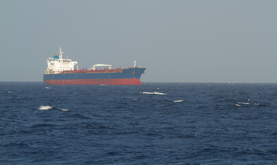 A merchant ship underway at sea in rough weather