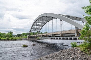 A bridge crosses the Montreal River in the small town of Latchford, Ontario on an overcast day.