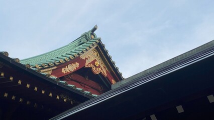 The early morning sunlight and the Japanese architectural rooftop shine on a summery season, the...