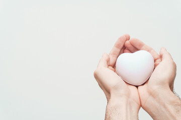 white heart in the middle of hands