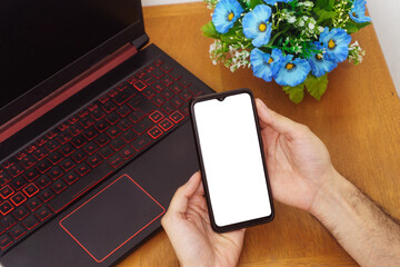 man using smartphone on his desk
