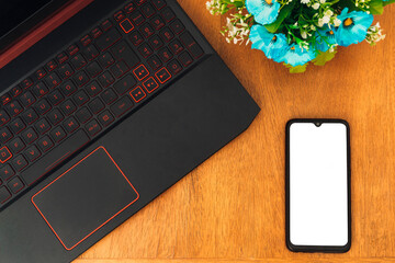 cell phone with white screen over of a wooden desk