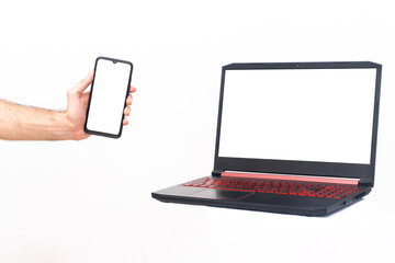 Male hand with cell phone and laptop with space for text. White background isolate