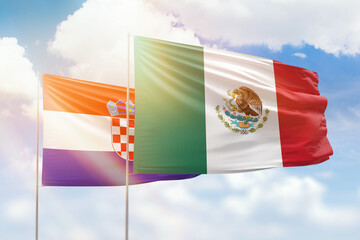Sunny blue sky and flags of mexico and croatia