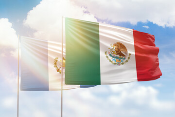 Sunny blue sky and flags of mexico and guatemala