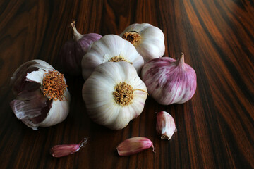 Garlic bulb. Garlic bulbs on the rustic wooden table under window light.