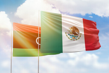 Sunny blue sky and flags of mexico and libya