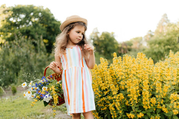 Girls picking flowers in a basket