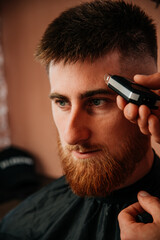 Shaving with wax in a barbershop with a shaver