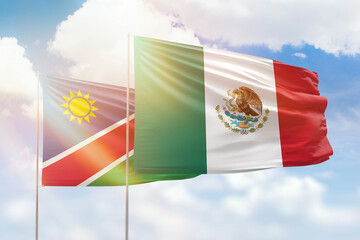 Sunny blue sky and flags of mexico and namibia