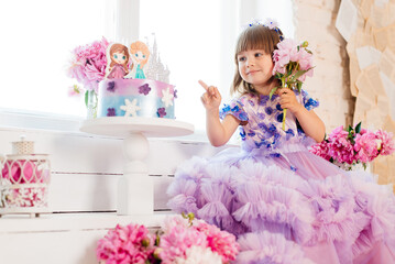 Fototapeta premium Portrait of a girl three years old in a pink dress