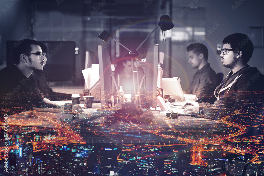 Aufkleber Getting the job done 247. Mutiple exposure shot of developers working late superimposed on a urban skyline at night.