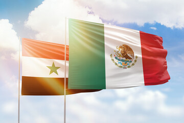 Sunny blue sky and flags of mexico and syria