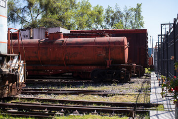 Fototapeta na wymiar old red train tanker sitting on the rain track station, museum of railway