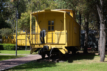 old yellow train wagon front view in a natural environment