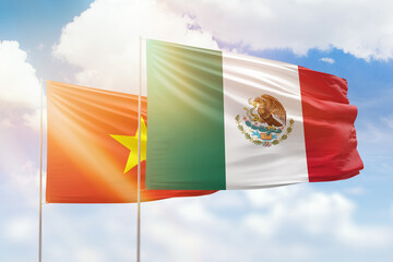 Sunny blue sky and flags of mexico and vietnam
