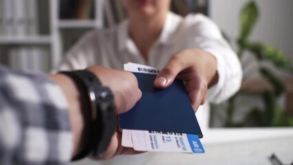 Getting tickets at a travel agency, Agent girl is issuing tickets for a flight to warm countries during summer vacation, Traveler getting ready to travel on vacation getting air tickets
