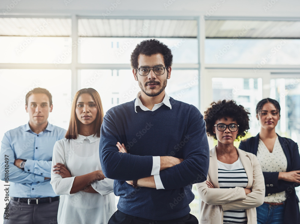 Poster The are very confident in their field of work. Portrait of a group of confident young businesspeople standing with their arms folded inside of the office together.