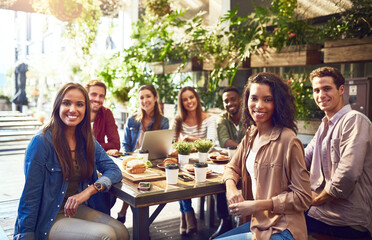 We always catch up, even just for a quick lunch. Cropped portrait of a group of friends out for lunch at a cafe.