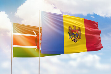 Sunny blue sky and flags of moldova and kenya
