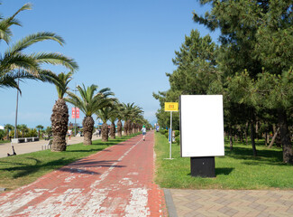 Place for advertising. Advertisement stand. Mocap among palm trees. Place for an inscription.