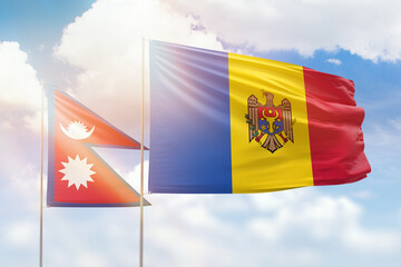 Sunny blue sky and flags of moldova and nepal