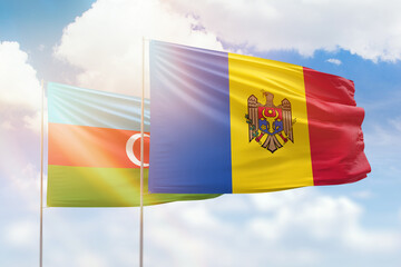 Sunny blue sky and flags of moldova and azerbaijan