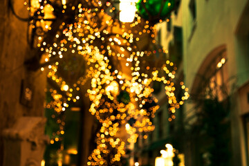 Christmas decoration of the street. Multicolored balls and fairy christmas lights. Old building facade, Palma de Mallorca, Spain. © Kseniya Iv
