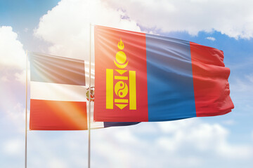 Sunny blue sky and flags of mongolia and dominican republic