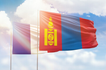 Sunny blue sky and flags of mongolia and france
