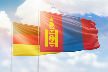 Sunny blue sky and flags of mongolia and germany