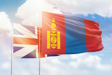 Sunny blue sky and flags of mongolia and great britain