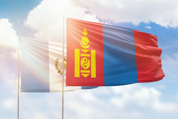 Sunny blue sky and flags of mongolia and guatemala