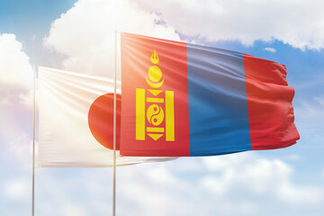 Sunny blue sky and flags of mongolia and japan