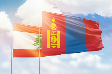Sunny blue sky and flags of mongolia and lebanon